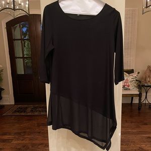 Elegant black knit blouse with sheer bottom.